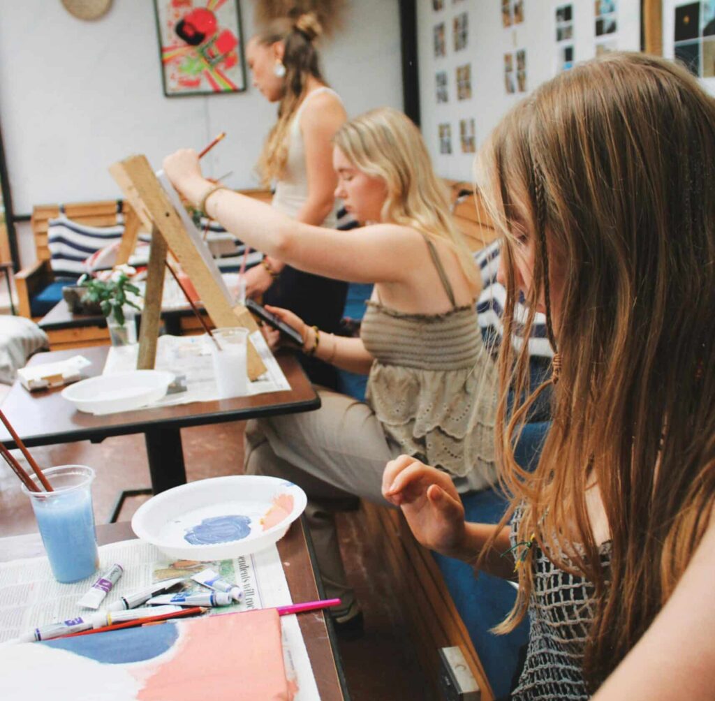 People creating artwork in an art class.